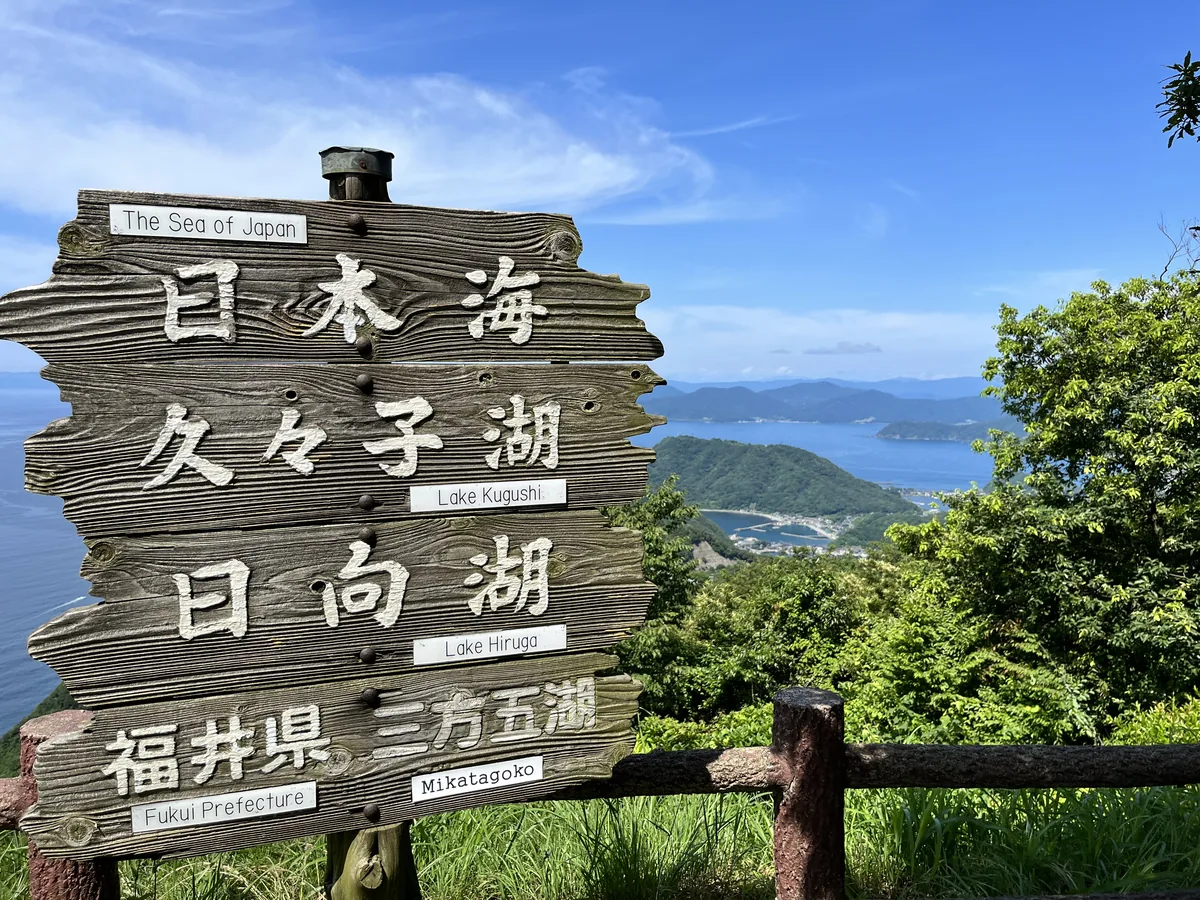 三方五湖レインボーライン山頂公園の案内板と、見下ろす久々子湖・日向湖（福井県）